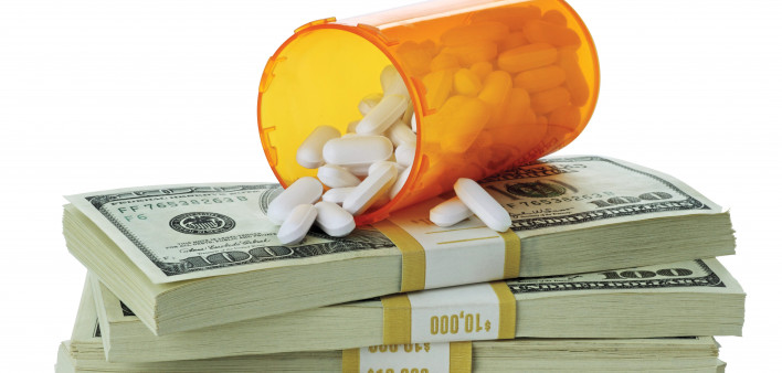 cost of healthcare bottle of pills on money