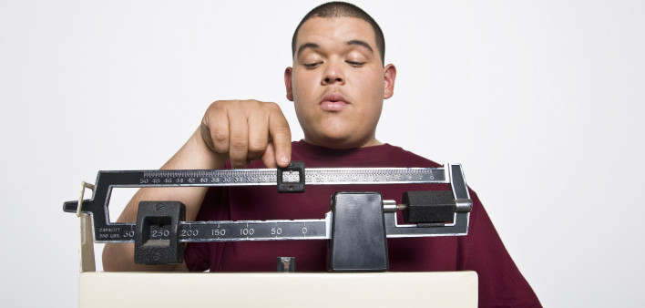 overweight hispanic teen on scale
