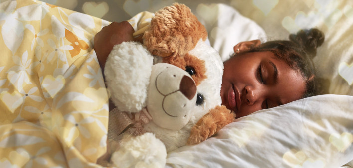 Shot of an adorable young girl sleeping peacefully in her bed
