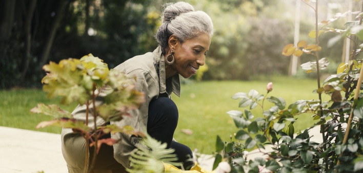 Retired senior woman gardening in back yard