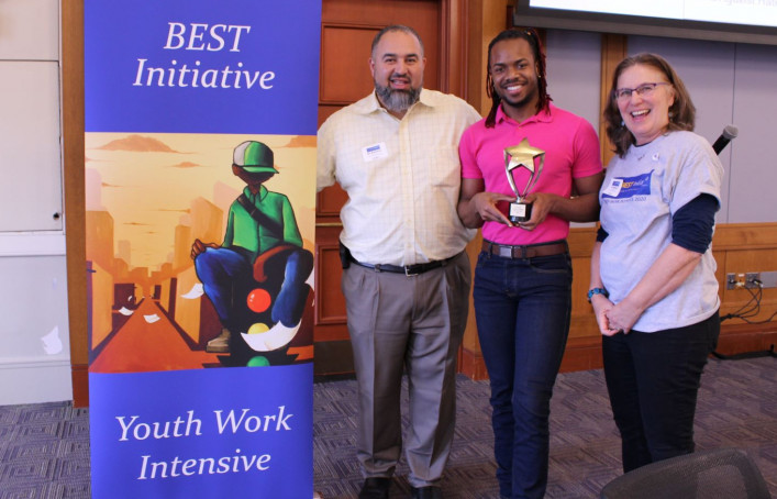 Lamar Brown-Noguera (center) of AIDS Project Worcester poses with his YOUTHIE Youth Worker of the Year award with Moacir “Mo” Barbosa (left) and Laurie Jo Wallace (right), both of the BEST Initiative at Health Resources in Action.