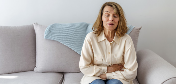 Senior woman suffering from stomach ache s
