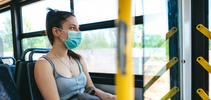 woman on bus wearing face mask