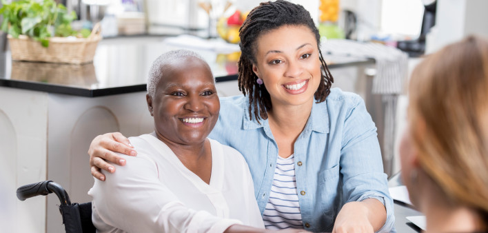 mother daughter talking to doctor smiling