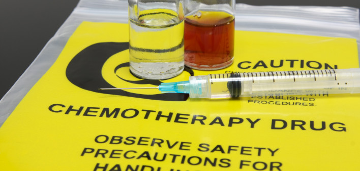 A syringe and two vials of chemotherapy drugs