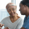 Senior woman with cancer reviews test results with female doctor