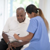 An Elderly Gentleman in His Doctors Office Receiving a Check-Up
