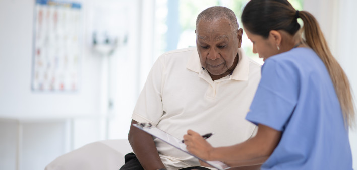 An Elderly Gentleman in His Doctors Office Receiving a Check-Up