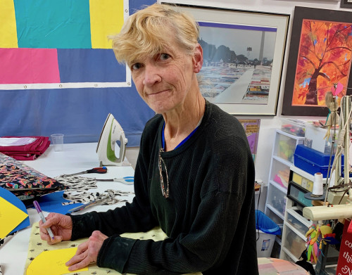 Gert McMullin sews masks out of extra fabric from the AIDS Memorial Quilt