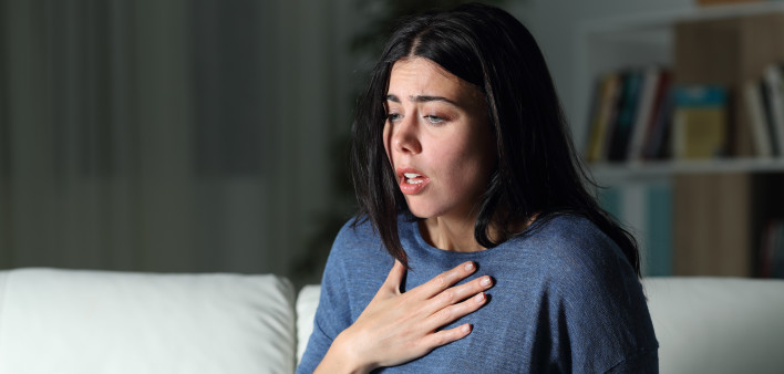 Woman suffering an anxiety attack alone in the night