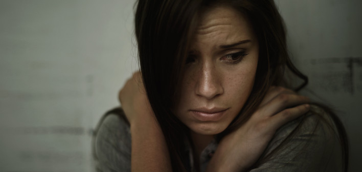 A young woman looking anxious and fearful