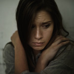A young woman looking anxious and fearful