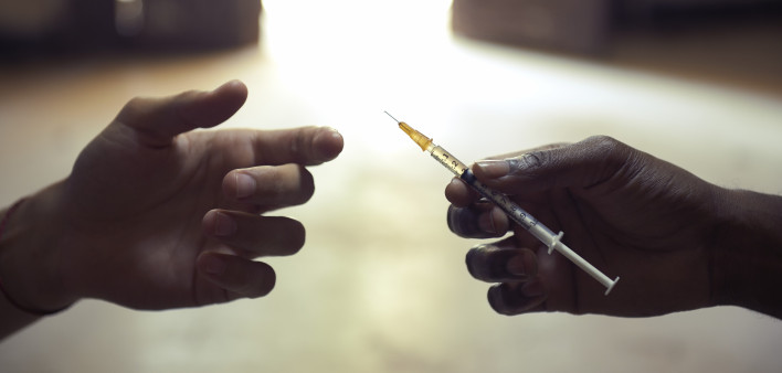 drug users passing a syringe