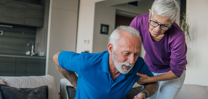Mature woman helping the man with backache