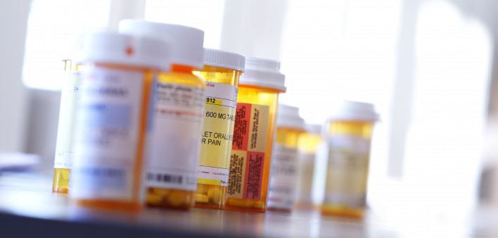 Several prescription medication bottles sit on a table.