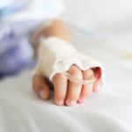 Saline intravenous (iv) drip in a Children's patient hand