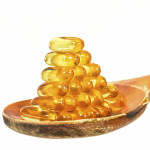 Vitamin D Capsules on wooden spoon