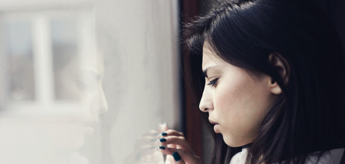 sad woman by window