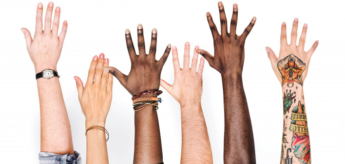 different race hands reaching upward