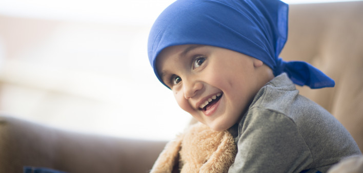 Little boy and his teddy bear after a chemotherapy treatment