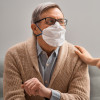 Doctor and senior man wearing facemasks