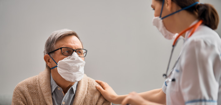 Doctor and senior man wearing facemasks