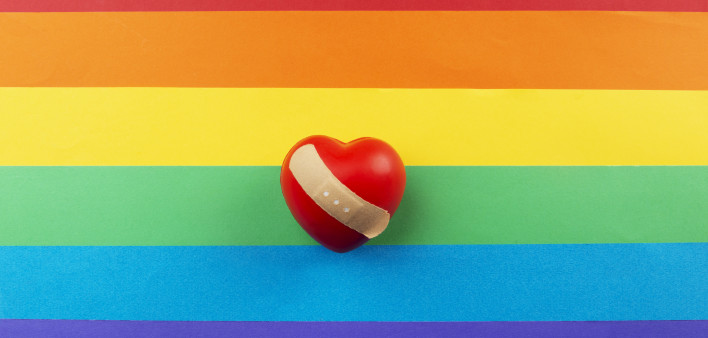 rainbow flag and heart with bandaid