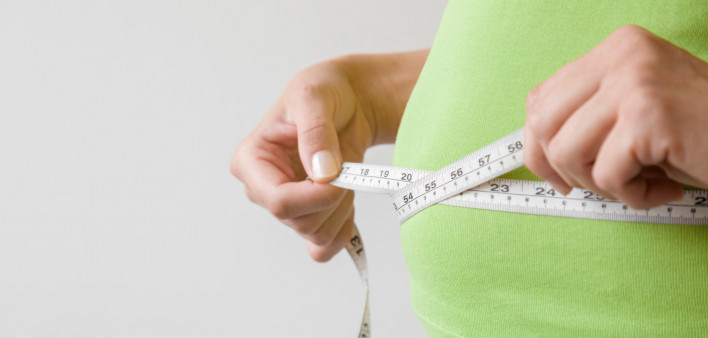 hands measuring waist measuring tape