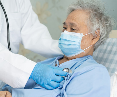 Asian senior or elderly old lady woman patient wearing a face mask in hospital for protect infection and kill Novel Coronavirus (2019-nCoV) Covid-19 virus.