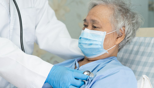 Asian senior or elderly old lady woman patient wearing a face mask in hospital for protect infection and kill Novel Coronavirus (2019-nCoV) Covid-19 virus.
