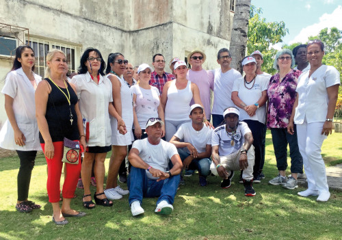 Staff of Los Cocos sanatorium staff and members of Proyecto Memorias with Elena Schwolsky, RN, MPH (third from right)  and Cleve Jones (seventh from right)