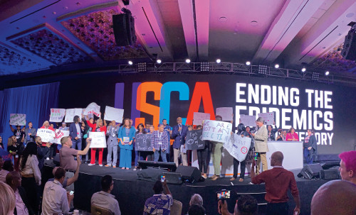 Activists at the U.S. Conference on AIDS in 2019 protest against molecular surveillance.