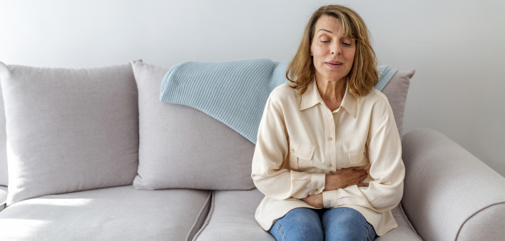 Senior woman suffering from stomach ache s