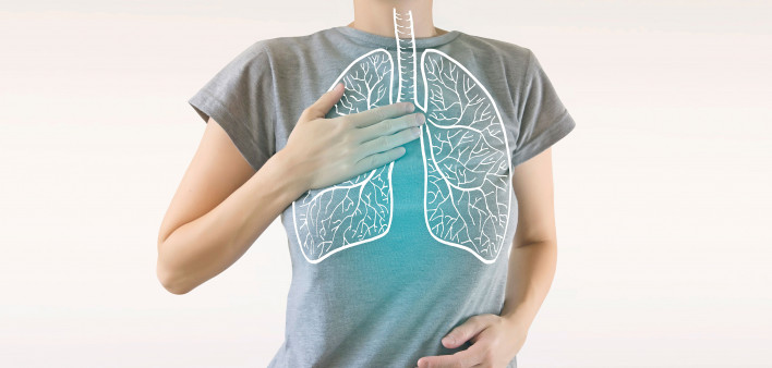 woman holding chest diagram of lungs
