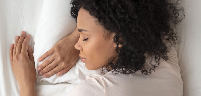 young woman sleeping in bed
