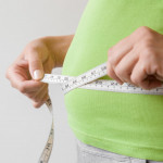 hands measuring waist measuring tape