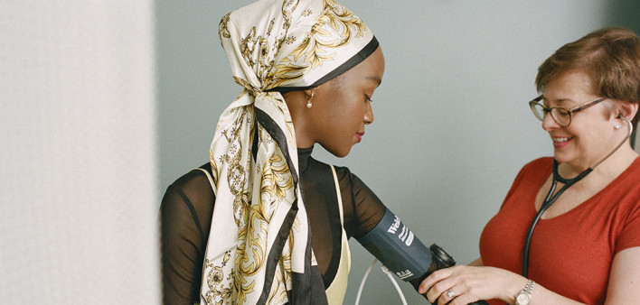 doctor takes blood pressure of patient