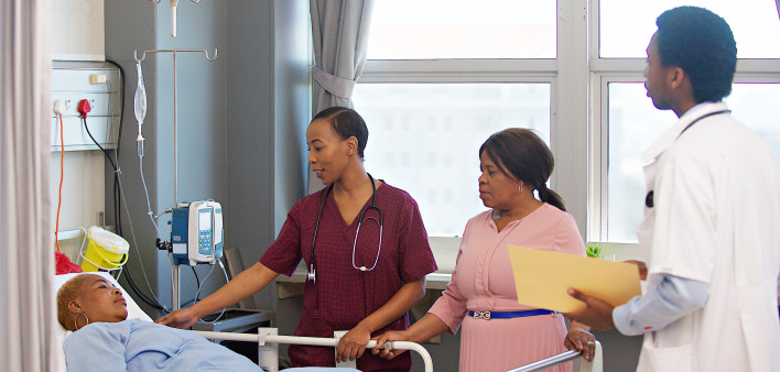 Female doctor comforting patient and friend in a hospital