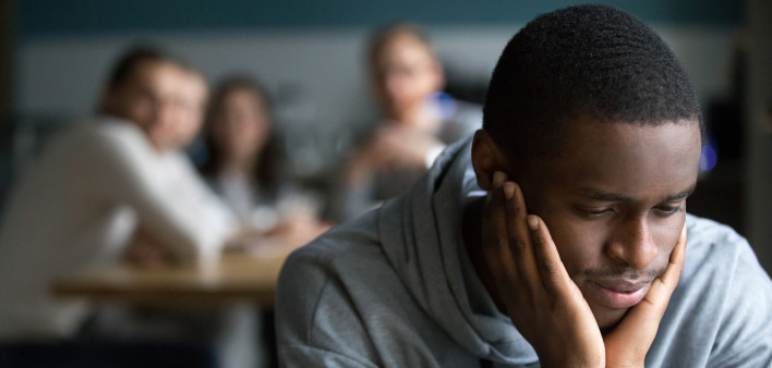 Black guy sit alone in cafe suffering from racial discrimination