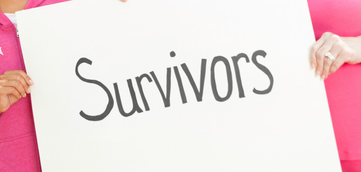 breast cancer awareness race holding sign survivors