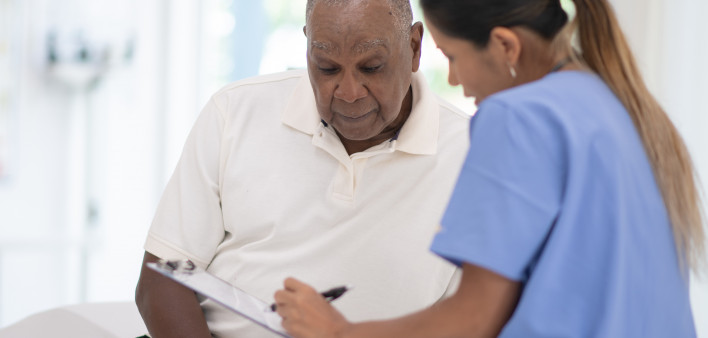 An Elderly Gentleman in His Doctors Office Receiving a Check-Up