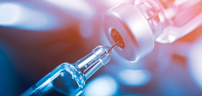 needle going into a vial vaccine medication