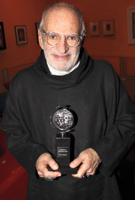 Larry Kramer Kramer holds  the 2011 Tony Award for Best Revival of a Play for The Normal Heart.