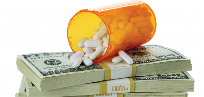 cost of healthcare bottle of pills on money