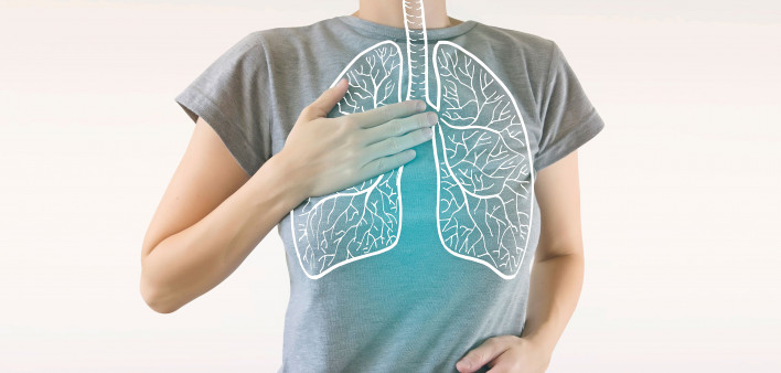 woman holding chest diagram of lungs