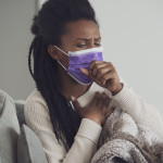 woman with mask coughing
