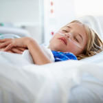Young Girl Sleeping In Intensive Care Unit