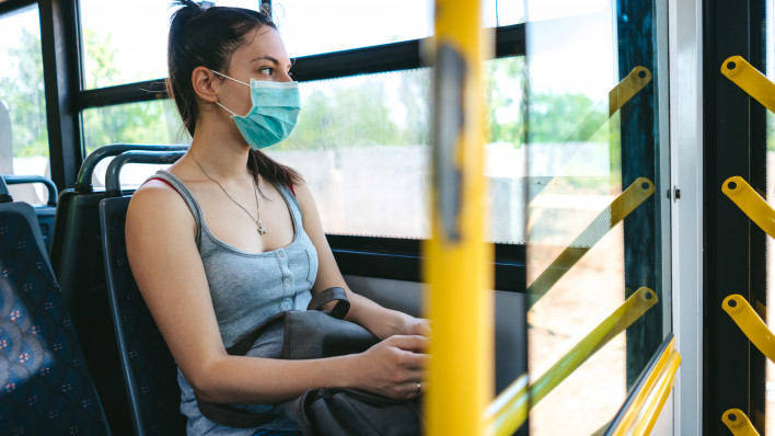 woman on bus wearing face mask