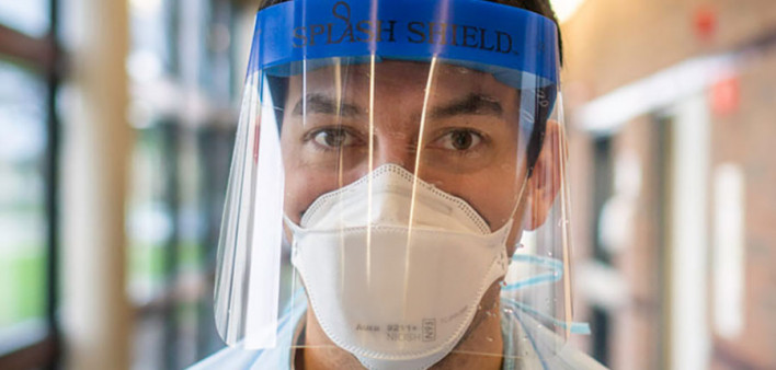 EIS Officer Guillermo “Memo” Sanchez wears a protective gown and face shield during an April 2020 visit to a Detroit nursing home.