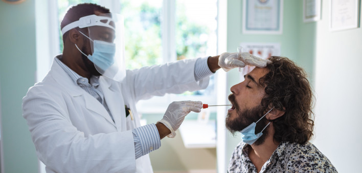Young man having a mouth swab test